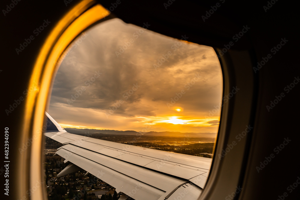 Airplane window with Sunrise view over Seattle, United States of America