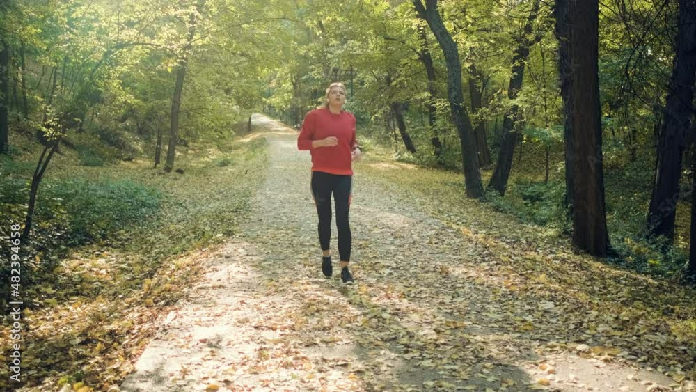 Young woman resting after running in park. Young woman resting after running in park.