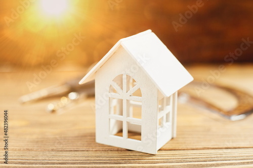 Rreal estate concepts with house model on wooden desk. photo