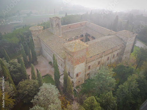 Aerial view of castle in Magione in dense fog near Lake Trasimeno in Umbria, Italy