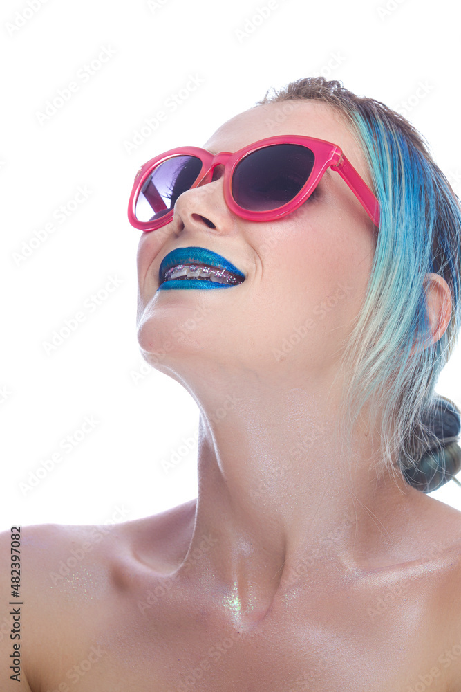 Portrait of Fancy Caucasian Female with Silky Skin and Teeth Brackets Wearing Red Sunglasses As Dental Healthcare Ideas. Portrait of Fancy Caucasian Female with Silky Skin and Teeth Brackets Wearing Red Sunglasses As Dental Healthcare Ideas.