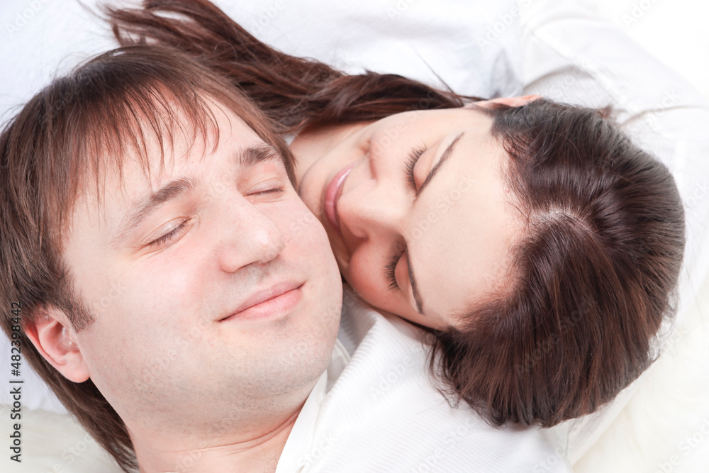 Family Ideas. Caucasian Loving Happy Couple Posing With Heads Turned to Each Other Closely Together Over White Background. Family Ideas. Caucasian Loving Happy Couple Posing With Heads Turned to Each Other Closely Together Over White Background.