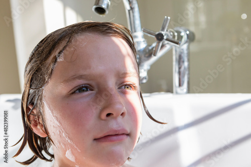 Eight year old boy in a bathtub photo