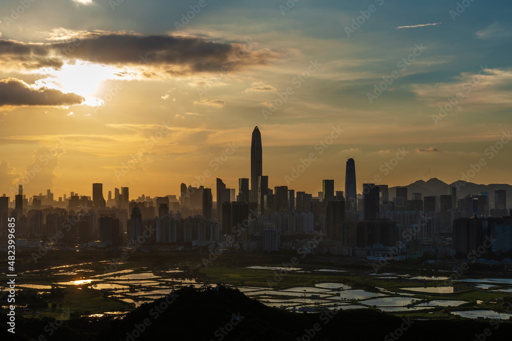 Silhouette of skyline of Shenzhen city, China under sunset. Viewed from Hong Kong border