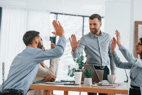 Using brainstorming technique. Group of business people that working on the project in the office