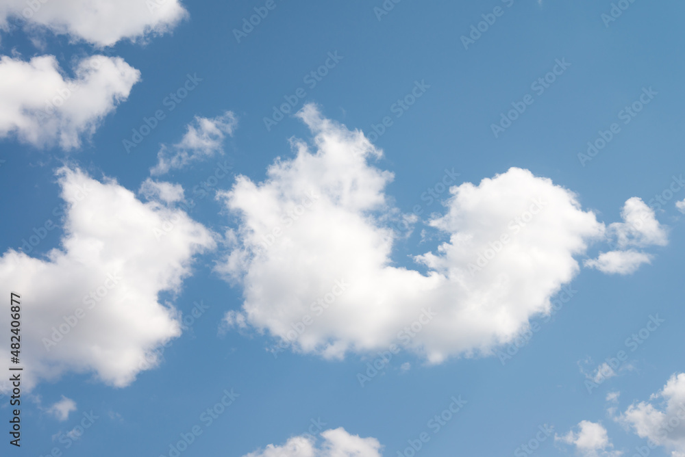 Fototapeta premium Smooth white clouds on clear blue sky background and copy space. Outdoor nature or save the earth concept.