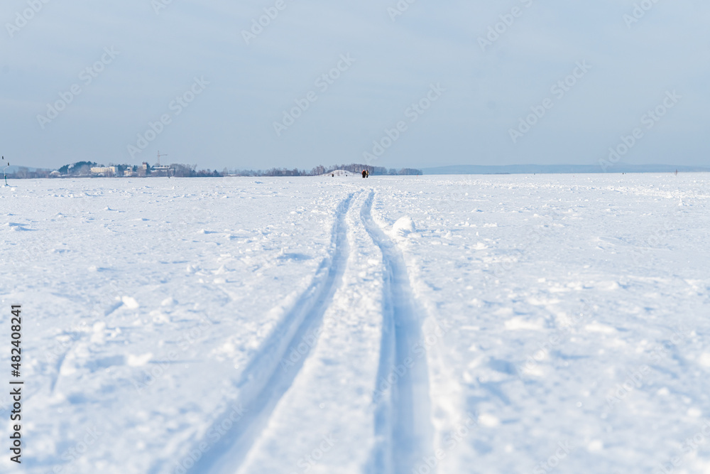 ski track on a snow-covered lake in winter, skiing, cross-country skiing, recreation