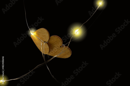 Black background with two wooden hearts.