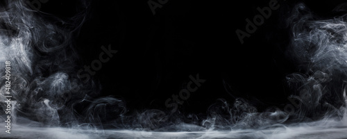 Panoramic view of the abstract fog. White cloudiness, mist or smog moves on black background. Beautiful swirling gray smoke. Mockup for your logo. Wide angle horizontal wallpaper or web banner.