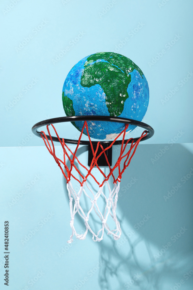 Small Earth ball in basketball hoop Small Earth ball in basketball hoop