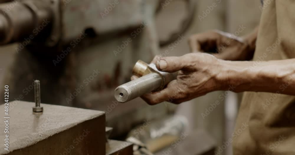 Close-up at hands of worker using industrial factory spare parts manufacturing tools. Mechanic Working with commitment in garage. Enthusiasm for professional. labor work with confident. Blue collar Close-up at hands of worker using industrial factory spare parts manufacturing tools. Mechanic Working with commitment in garage. Enthusiasm for professional. labor work with confident. Blue collar