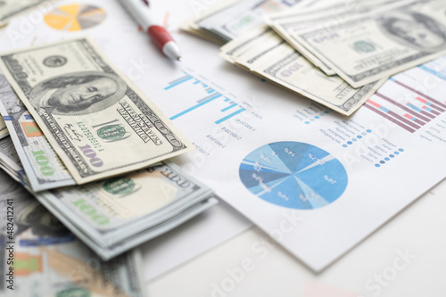 money concept, graph, chart document and pen on desktop.