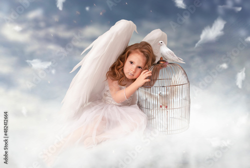 Cuadro en lienzo a cute charming girl in an angel costume with huge wings sits on a cloud on Valentine's Day or February 14