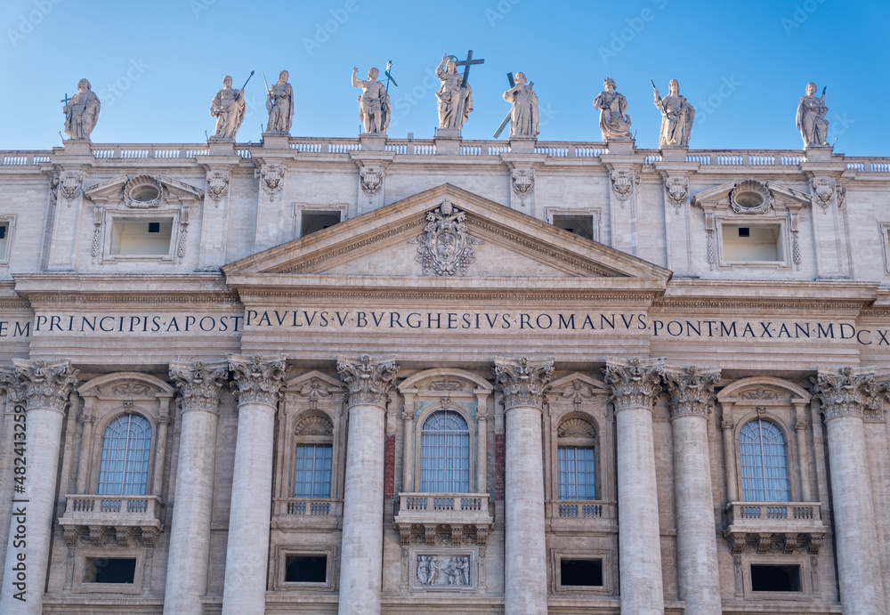 Low angle view of exterior and entrance of Saint Peter's Basilica.