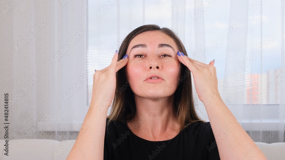Caucasian woman doing face massage along massage lines and points with hands. Facial massage. Hygiene, beautician, make-up. Facial gymnastics. System of exercises improve skin yourself Caucasian woman doing face massage along massage lines and points with hands. Facial massage. Hygiene, beautician, make-up. Facial gymnastics. System of exercises improve skin yourself