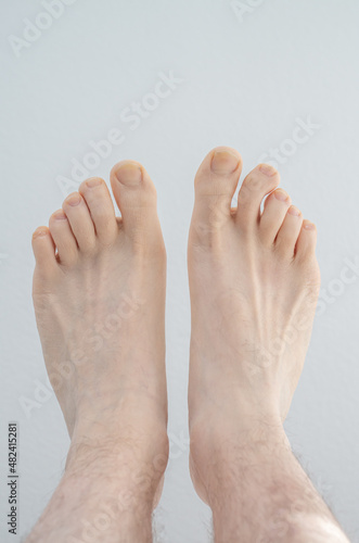 Caucasian male bare feet. Close up shot, isolated on white background, top view