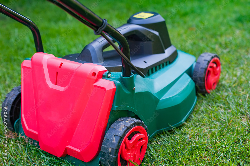 Lawn mower in the backyard Lawn mower in the backyard