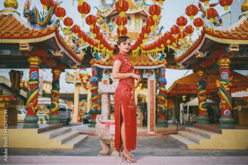 Beautiful Asian Chinese Woman Wearing Cheongsam Traditional Red Dress Fashion Posting Chinese Lunar New Year. photo