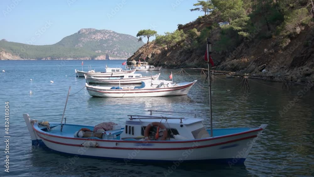 Fishing boats anchored at beautiful sea bay with mountains. Fishing boats anchored at beautiful sea bay with mountains.