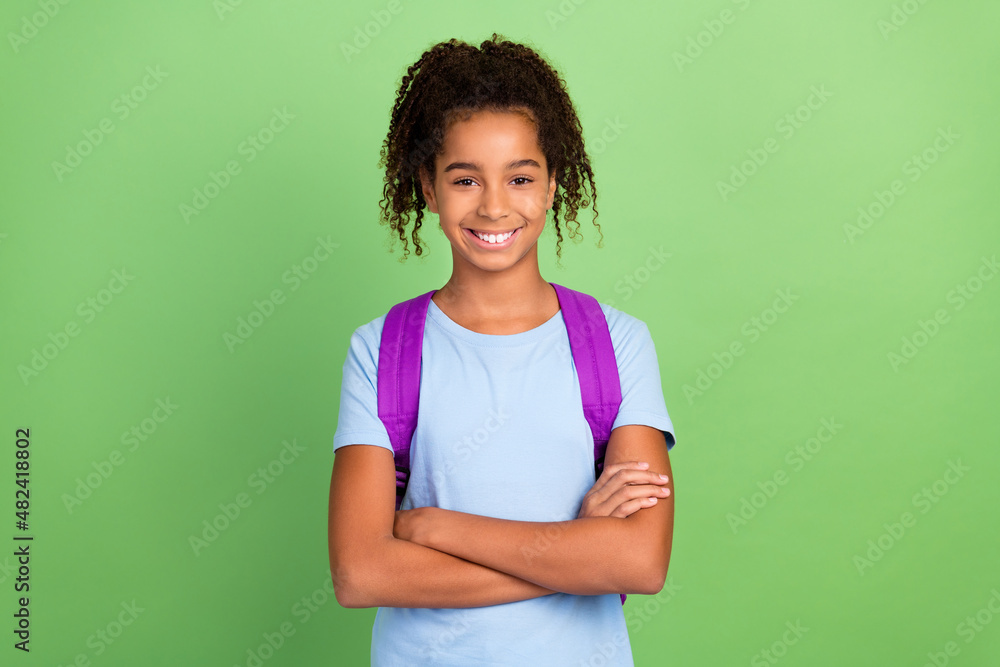 Photo of young black girl confident folded arms study education rucksack isolated over green color background Photo of young black girl confident folded arms study education rucksack isolated over green color background