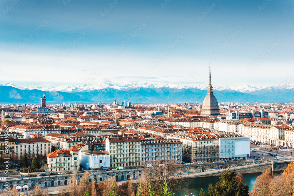 Panoramic view of the historic center of Turin (Italy) with the Mole Antonelliana overlooking the city with the snow-capped alps on the background.