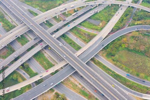 Aerial view of cars driving on highway or moterway. Overpass bridge street roads in connection network of architecture concept. Top view. Urban city, Bangkok, Thailand.