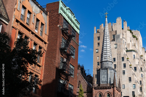 Row of Old Brick Residential Buildings with a Church along a Street on the Upper East Side of New York City