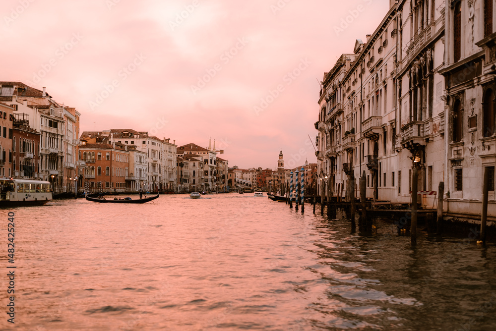 From the boat in the middle of a canal in venice at sunset.