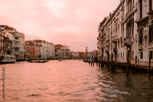 From the boat in the middle of a canal in venice at sunset.