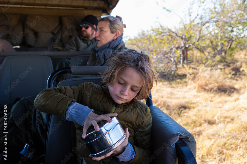 young boy in safari vehicle,Okavango Delta, Botswana young boy in safari vehicle,Okavango Delta, Botswana