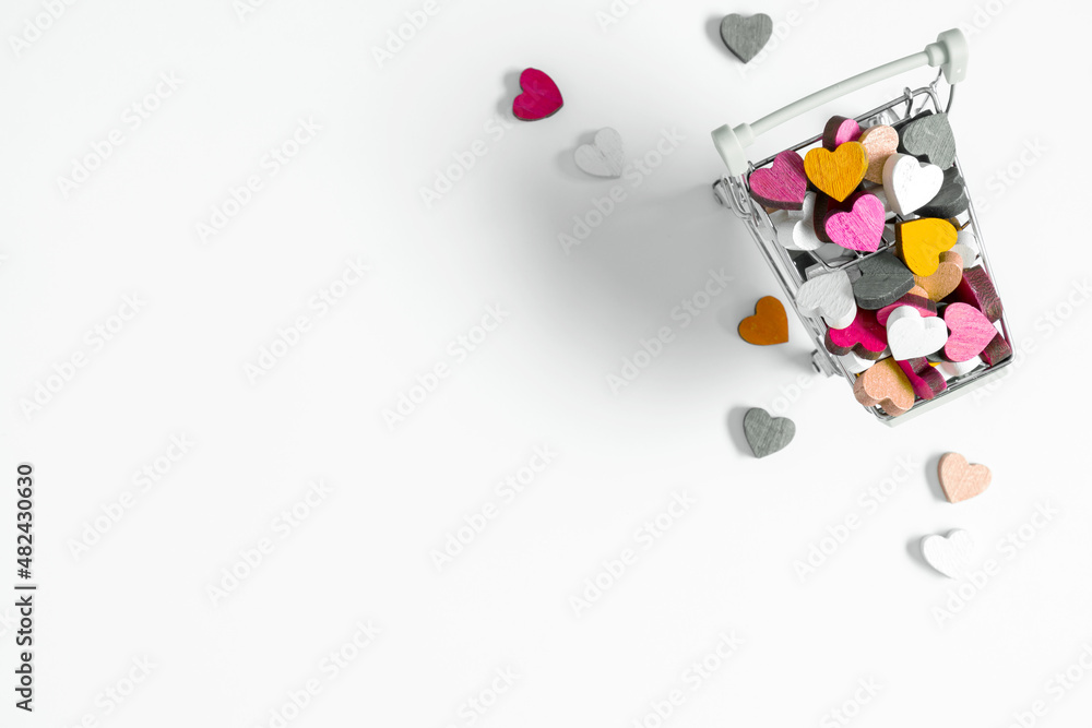 Valentine's Day background. Hearts in shopping cart and supermarket trolley on white background. Valentine day concept.  