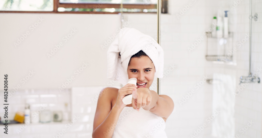 Make the morning shine. Shot of an attractive young woman singing while going through her morning beauty routine at home. Make the morning shine. Shot of an attractive young woman singing while going through her morning beauty routine at home.