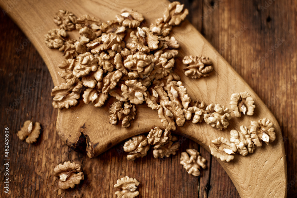 Peeled walnuts. On a wooden background. Healthy food. Natural background. Peeled walnuts. On a wooden background. Healthy food. Natural background.