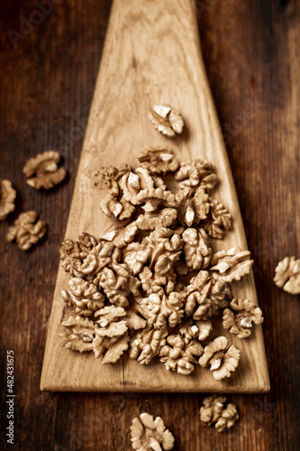 Peeled walnuts. On a wooden background. Healthy food. Natural background.
