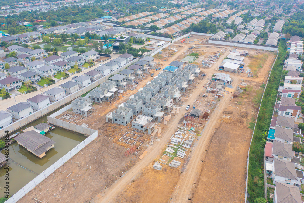Aerial view of residential neighborhood with under construction site. Urban housing development from above. Top view. Real estate in urban city town. Property real estate.