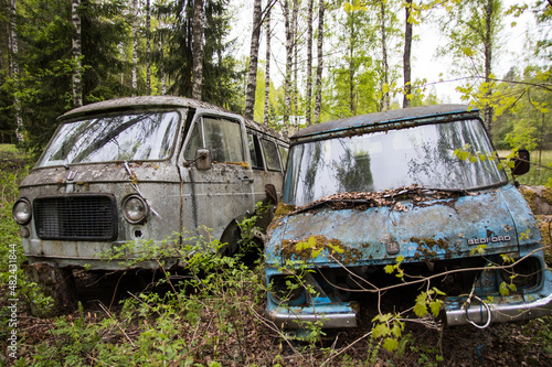 Old rusty abandoned van in the woods