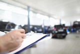 Car dealer places order in car dealership