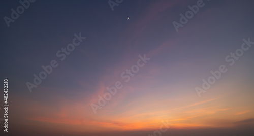 Sunset sky. Abstract nature background. Dramatic blue with orange colorful clouds in twilight time.