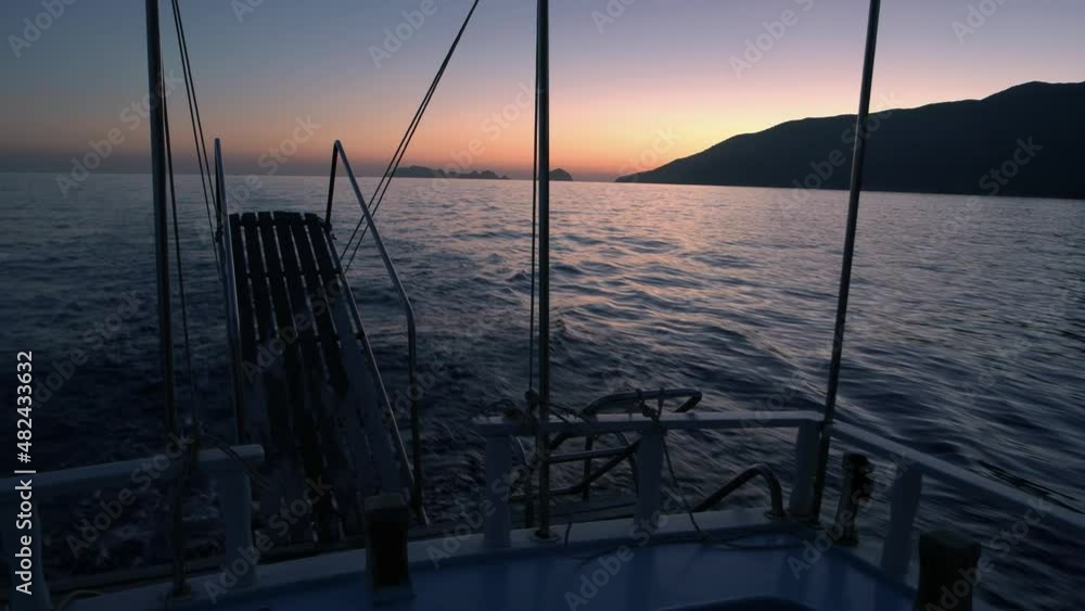 Sailing yacht at sunset in the open sea. Sailing yacht at sunset in the open sea.