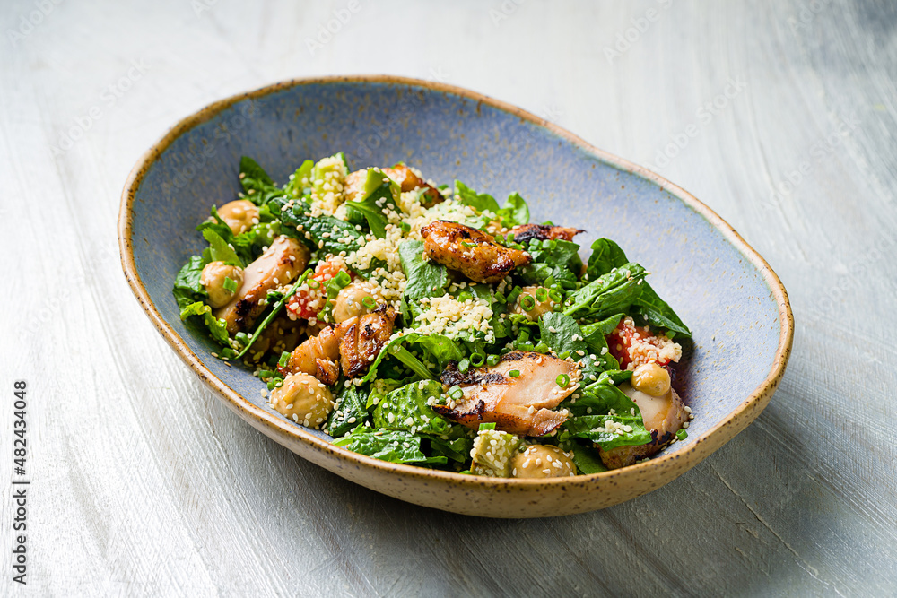 Salad caesar with chicken on plate on grey table Salad caesar with chicken on plate on grey table