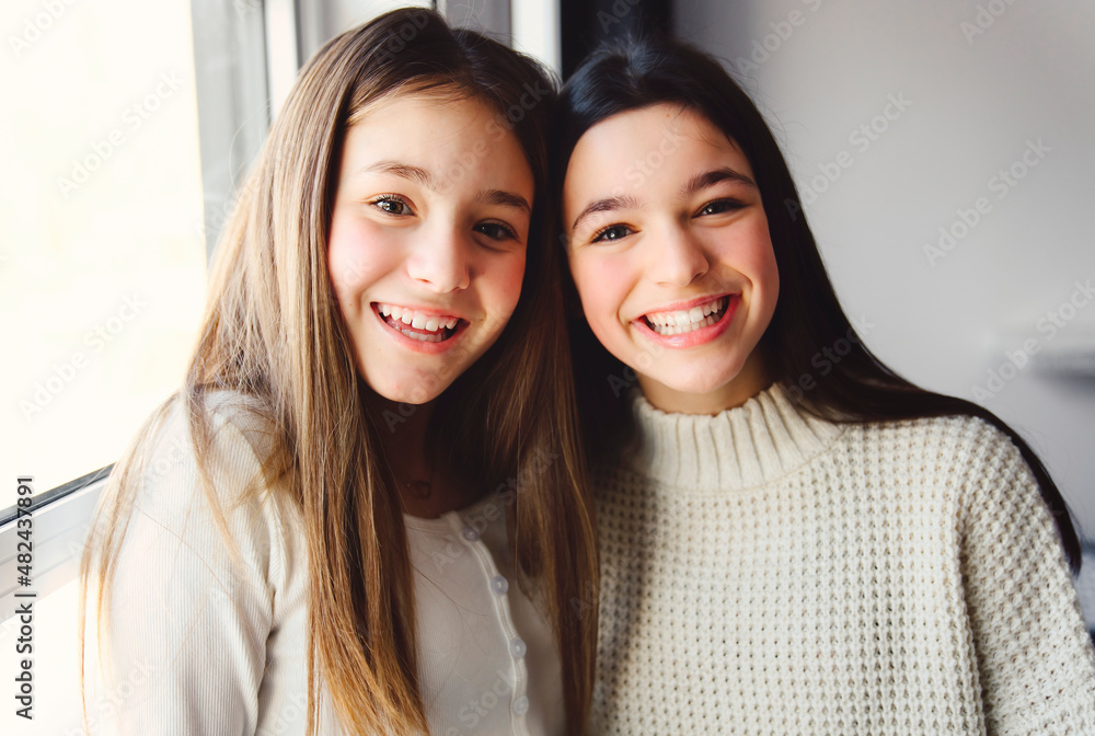 Two Teens spending time on bedroom at home Two Teens spending time on bedroom at home