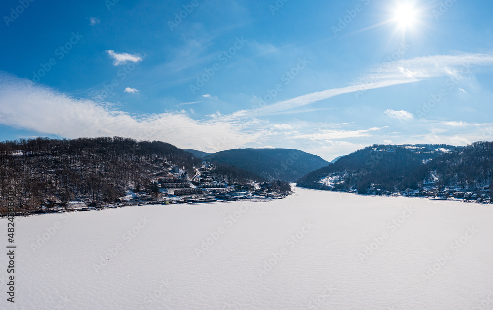 Aerial drone panorama of the frzoen and snow covered Cheat Lake looking upriver into the gorge near Morgantown, West Virginia