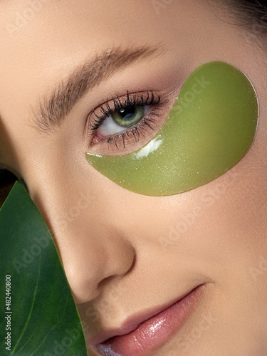 Woman with green eye patches under her eyes