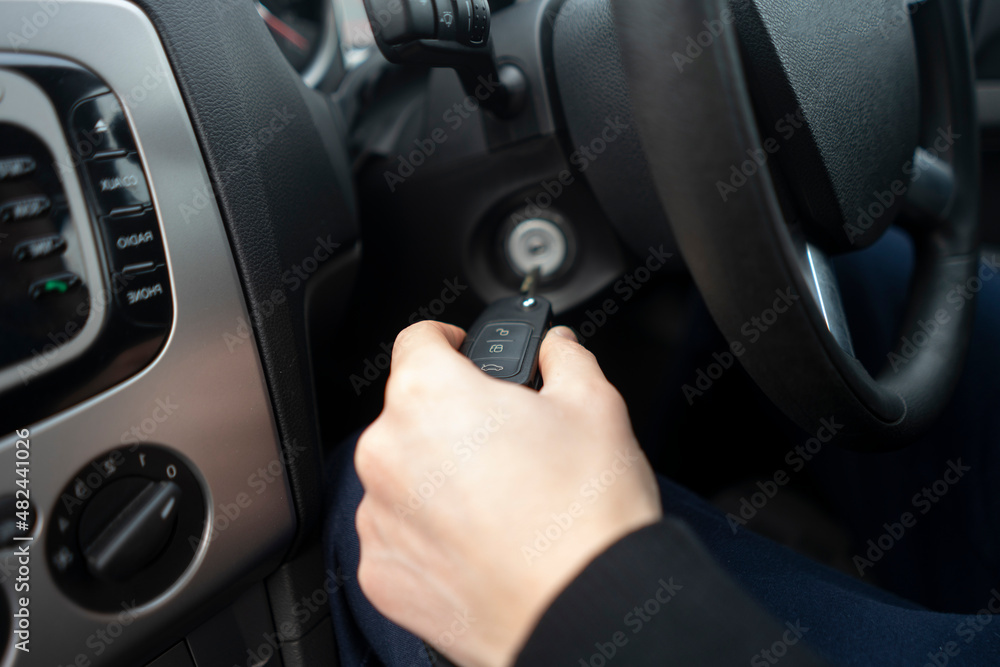 driver with car keys starting the vehicle ignition