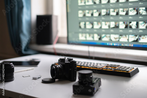 Bild auf Leinwand photo studio, photographer workplace table with retro style camera and desktop e