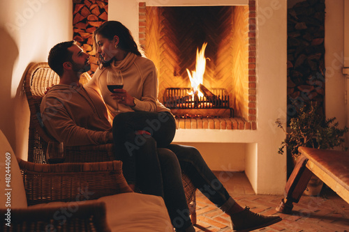 Honeymooners relaxing in front of a fireplace in a hotel