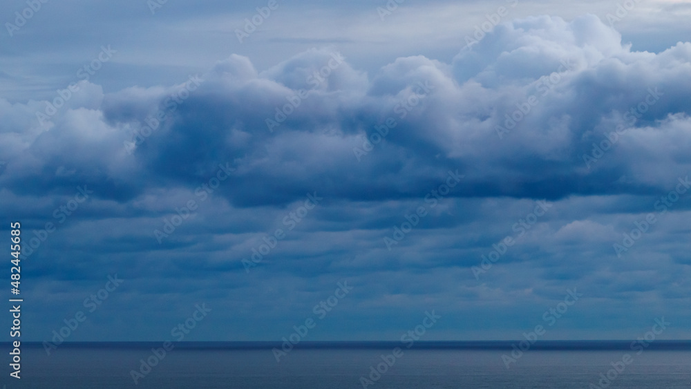 Panoramic view of bright blue sea, blue sky with fluffy white clouds Panoramic view of bright blue sea, blue sky with fluffy white clouds