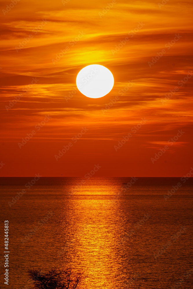  Fantastic sunset over ocean. The sun goes down over the sea. Dramatic Sunset Sky
