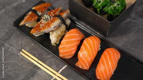 sake sushi, unagi sushi on a serving plate. sushi on a dark background. Japanese food
