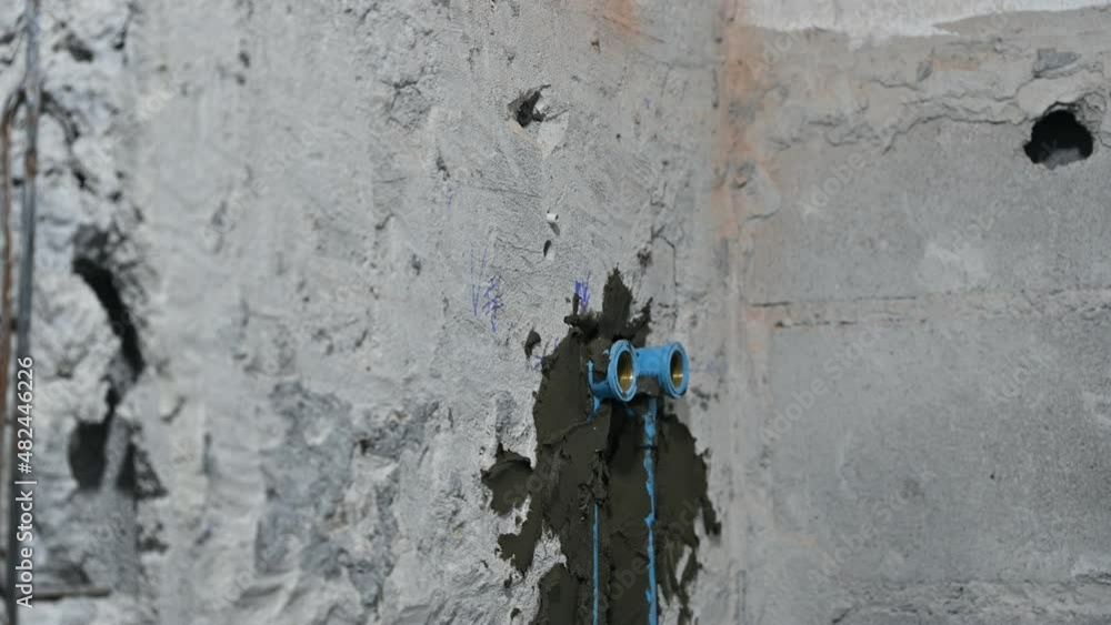 Plasterer plastering on brick wall in bathroom Plasterer plastering on brick wall in bathroom